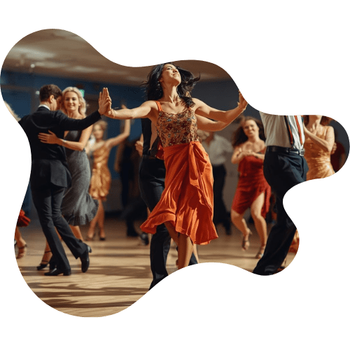 Dancers performing energetically in a lively ballroom setting.
