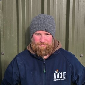 Man with a beard wearing a gray beanie and jacket.